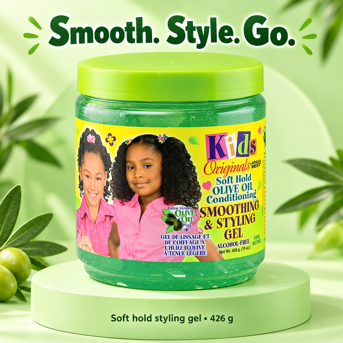 A jar of Kids Originals Soft Hold Olive Oil Conditioning Smoothing & Styling Gel, featuring a bright green lid and a colorful label with children, displayed on a light green pedestal with olives and the text 'Smooth. Style.