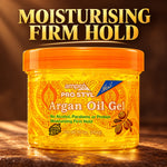 A jar of ampro Pro Styl Argan Oil Gel with an orange lid and golden-yellow gel visible through the clear container, set against a dark brown background with large gold text reading 'MOISTURISING FIRM HOLD'.