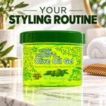 A jar of ampür Pro Styl Olive Oil Gel styled on a marble countertop with a blurred bathroom background and large text reading 'YOUR STYLING ROUTINE' at the top.