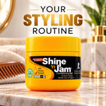A jar of Shine 'n Jam Conditioning Gel sits on a marble countertop in a bathroom setting, with a wooden comb, towel, and gold-toned accessories blurred in the background. Large text at the top reads 'YOUR STYLING ROUTINE'.