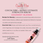 Camille Rose Cocoa Nibs + Honey Ultimate Strength Serum bottle on a pink background with product details.
