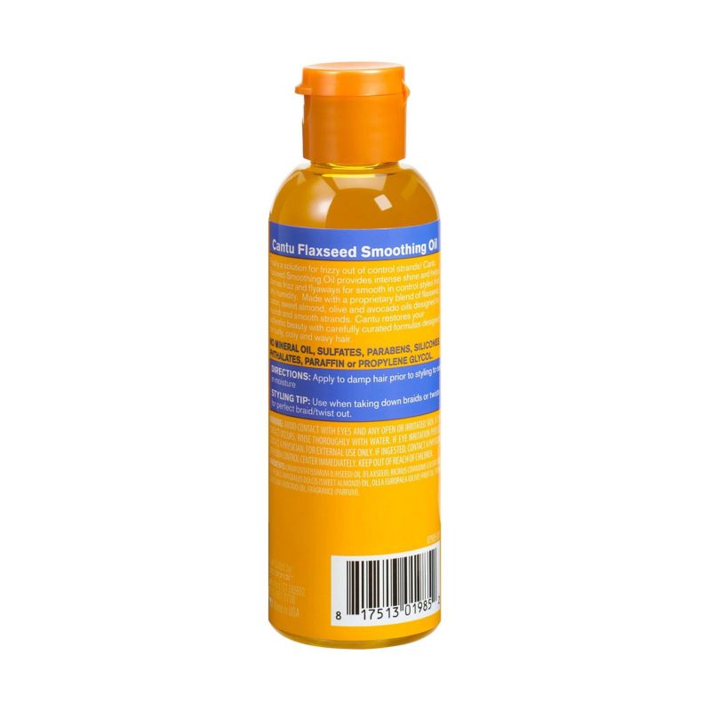 Applying Cantu Flaxseed Smoothing Oil to damp curly hair for smooth, shiny results