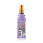 Purple spray bottle with gold nozzle on a white background
