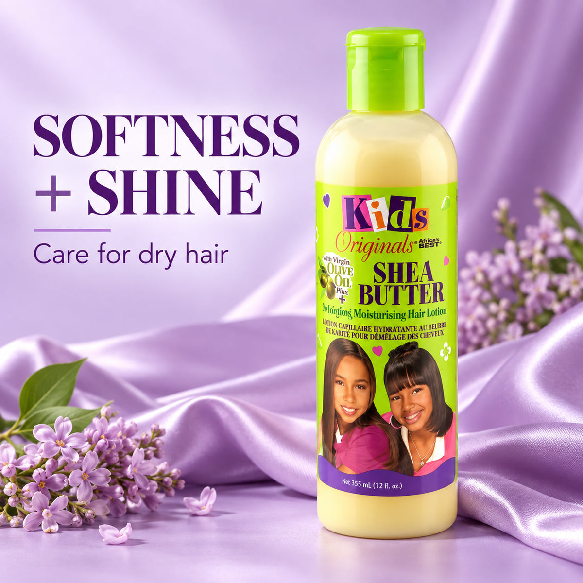 A bottle of Kids Original Naturals Shea Butter Moisturizing Hair Lotion stands on a lavender satin surface with lilac flowers. The bottle is pale yellow with a bright green cap and a lime green label featuring the product name and a photo of two children.