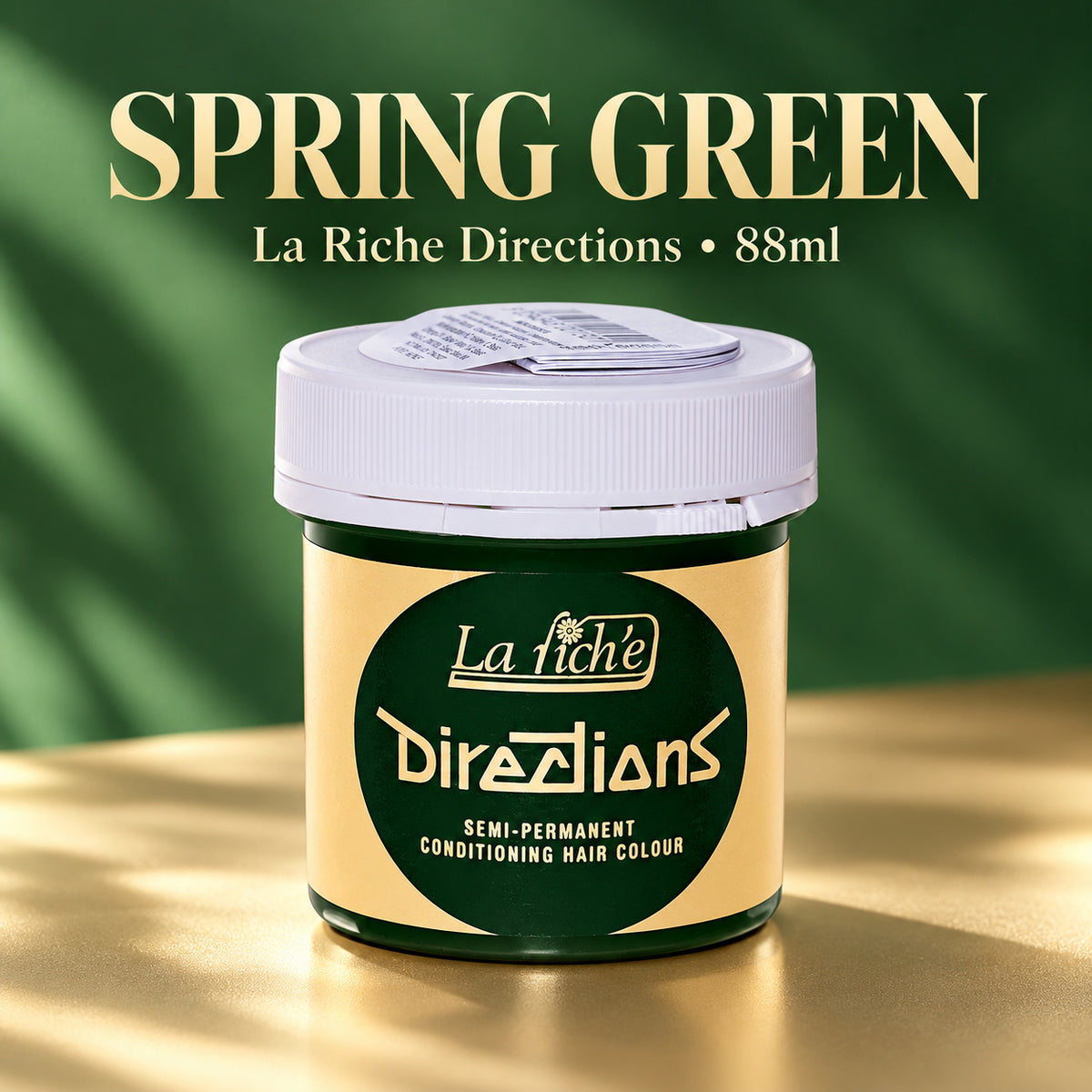 A jar of La Riche Directions semi-permanent conditioning hair colour in Spring Green, shown on a gold surface with a dark green background and text overlay.