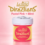 A jar of La tiche' Directions semi-permanent conditioning hair colour in pastel pink, shown on a soft pink background with product branding text above.