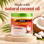A jar of ORS Coconut Oil Hair & Scalp Hairdress cream sits on a round stone pedestal, with a cut coconut and coconut slices beside it. Large text at the top reads 'Made with natural coconut oil' against a warm beige background with soft leaf shadows.