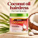 A jar of ORS Coconut Oil Hairdress hair and scalp treatment sits on a stone surface with a cut coconut and palm leaves around it. Large text at the top reads 'Coconut oil hairdress For hair & scalp'.