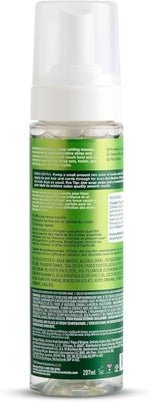 Clear bottle with green label and white cap on a white background