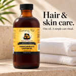 A bottle of Sunny Isle Jamaican Black Castor Oil stands on a stone surface with folded white towels and a blurred plant in the background. Text on the right reads 'Hair & skin care.