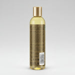 Bottle of shampoo with a gold cap on a white background